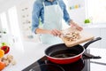 Cropped photo of housewife chef hold champignon cutting knife slices putting on frying pan cooking tasty dinner family