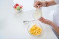 Cropped photo of housewife hands holding pouring milk jug cooking breakfast cornflakes healthy eating concept keeping to Royalty Free Stock Photo