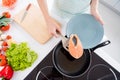 Cropped photo of housewife lady hands put fresh raw salmon fillet steak turning side lying frying pan cooking family Royalty Free Stock Photo