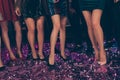 Cropped photo of lovely attractive fancy girls legs short mini dress high heels confetti floor modern club indoors