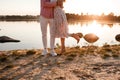 Cropped photo of loving couple is hugging on the lake at sunset. Beautiful young couple in love walking on the shore of the lake Royalty Free Stock Photo