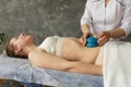 Cropped photo of masseuse doctor woman applying blue silicone cups on bare belly of young woman wearing beige underwear. Royalty Free Stock Photo