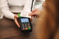 Cropped photo of mature woman paying credit card in cafe Royalty Free Stock Photo