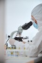 Woman scientist examining a coronavirus vaccine sample