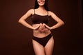 Cropped photo no retouch of attractive young woman heart gesture body positive wear trendy lingerie isolated on brown Royalty Free Stock Photo