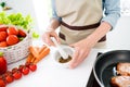Cropped photo of old woman grandmother hold hand mortar seasoning cook indoors inside house home kitchen