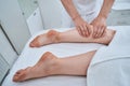 Massotherapist giving a deep tissue leg massage Royalty Free Stock Photo