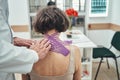 Male doctor using the kinesiology taping technique for neck pain