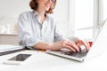 Cropped photo of pretty brunette woman typing email on laptop co Royalty Free Stock Photo