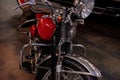 Cropped photo of red and metallic colored clean motorcycle standing indoors