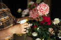 Cropped photo of senior woman wearing checkered shirt, spraying bouquet of pink, white roses with yellow pulverizer. Royalty Free Stock Photo