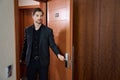 Cropped photo of serious guy entering hotel room Royalty Free Stock Photo