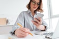 Cropped photo of serious young woman in glasses holding mobile p Royalty Free Stock Photo