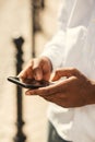 Hands of man using the Internet in his smartphone