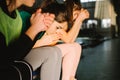 Cropped photo of sportswear girls sitting on the bench and cheering for their team. Team play. Hard football. Royalty Free Stock Photo