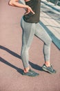 Sporty woman in tights and sneakers stock photo Royalty Free Stock Photo