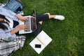 Cropped photo of student girl, using laptop, sitting on grass, o Royalty Free Stock Photo