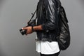 Cropped photo of stylish african man with backpack holding photo