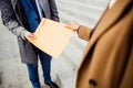 Two modern Caucasian business people standing outdoors