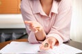 Cropped photo of a woman counting coins for paying invoices with bills on the table, there is not enough money. Royalty Free Stock Photo