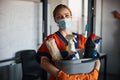 Cleaner in a face mask showing her cleaning products Royalty Free Stock Photo