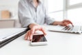 Cropped photo of woman in shirt holding smartphone while sitting Royalty Free Stock Photo