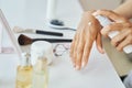 Adult dark-skinned woman applying a beauty product