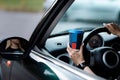 cropped photo of woman& x27;s hand holding blue paper cup of coffee in car. Hot drink take away. Travel with coffee Royalty Free Stock Photo