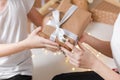 Cropped photo of Young man giving a gift box to his surprised happy woman. party moment. Hands of young boyfriend Royalty Free Stock Photo