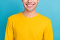 Cropped photo of young optimistic guy wear yellow shirt isolated on blue color background