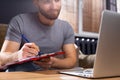 Cropped photo of young student studying online in front of laptop at home. The concept of learning during a pandemic and maximum