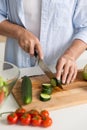 Cropped picture of mature attractive man cooking salad. Royalty Free Stock Photo