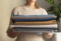 cropped picture of Person holding stack of natural cotton fabric at home