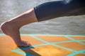 Cropped picture of woman in her SUP Yoga practice on the water