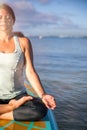 Cropped picture of woman in meditation after her SUP Yoga on the