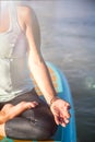 Cropped picture of woman in meditation after her SUP Yoga on the