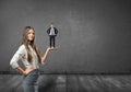 Cropped portrait of big businesswoman holding small businessman on her palm Royalty Free Stock Photo