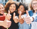 Youve got our vote. Cropped portrait of a diverse group of college friends giving thumbs up while standing outside. Royalty Free Stock Photo