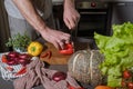 Cropped portrait of male hands cutting yellow bell pepper