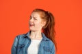 Cropped portrait of one young caucasian woman looking mistrustful isolated over red background