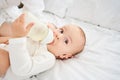 Cropped portrait of a smiling little toddler holding a bottle Royalty Free Stock Photo