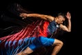 Cropped portrait of young athletic man, professional runner over black background. Stroboscope effect.