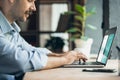 Concentrated, focused. Image of one young businessman, manager working on laptop. Side view. Royalty Free Stock Photo