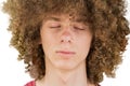 Cropped portrait of a young curly European man with long curly hair and closed eyes close up. very lush male hair. curling hair Royalty Free Stock Photo