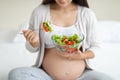 Cropped of pregnant woman eating healthy vegetable salad at home Royalty Free Stock Photo