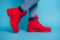 Cropped profile photo of fit lady legs sneaker tiptoe wear stylish red rubber shoes boots denim jeans isolated teal