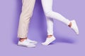 Cropped profile side photo of couple legs wear pants white shoes date day together isolated on purple color background Royalty Free Stock Photo