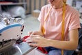 cropped seamstress in factory sewing using industrial sewing machine, very accurate