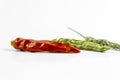 Cropped shoot of dried red and green colored peppers on white background