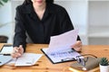 Accountant checking financial documents and using calculator on office desk. Royalty Free Stock Photo